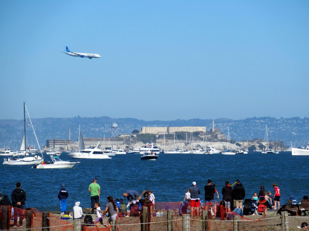 A United Airlines 777 flying low over the San Francisco Bay and Alcatraz Island during Fleet Week 2021