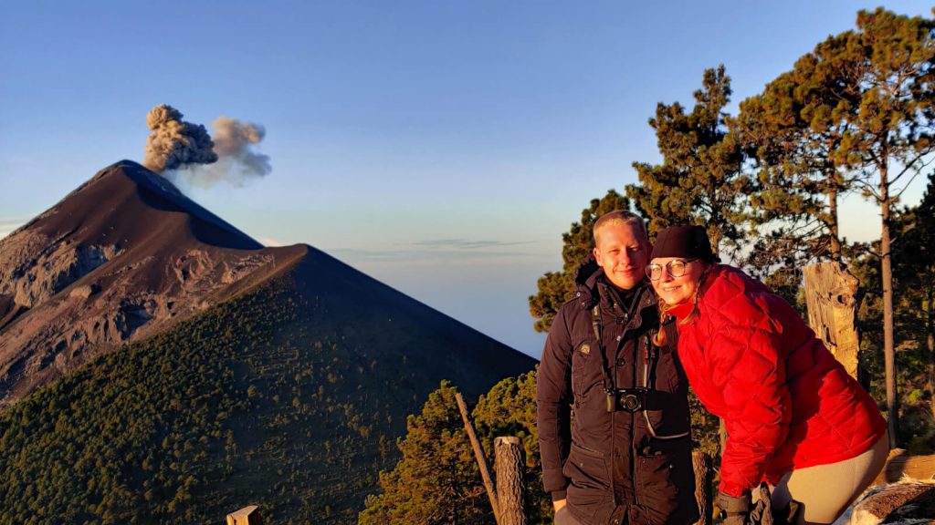 Adam and Zoe at the top of Acatenango with the erupting Fuego behind