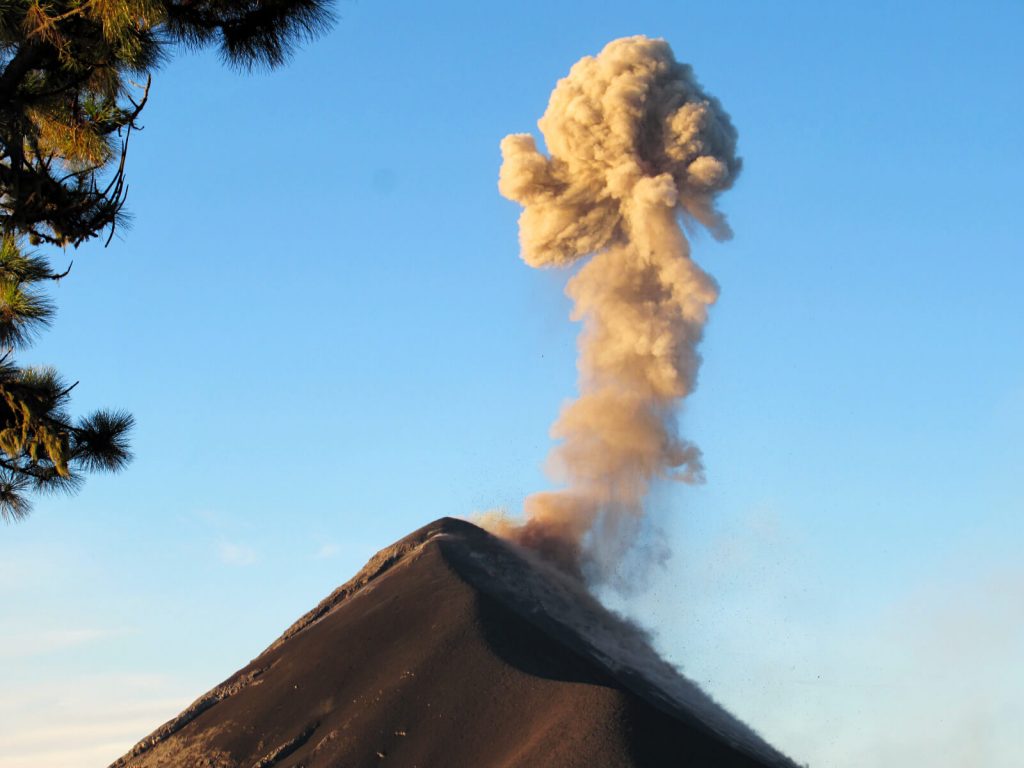 Fuego erupting a large ash cloud high into the sky